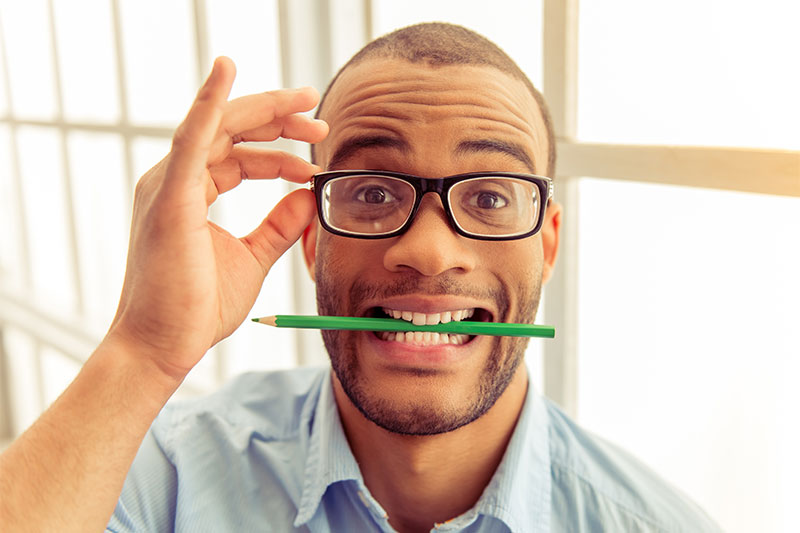 Hold a pencil between your teeth to boost your mood